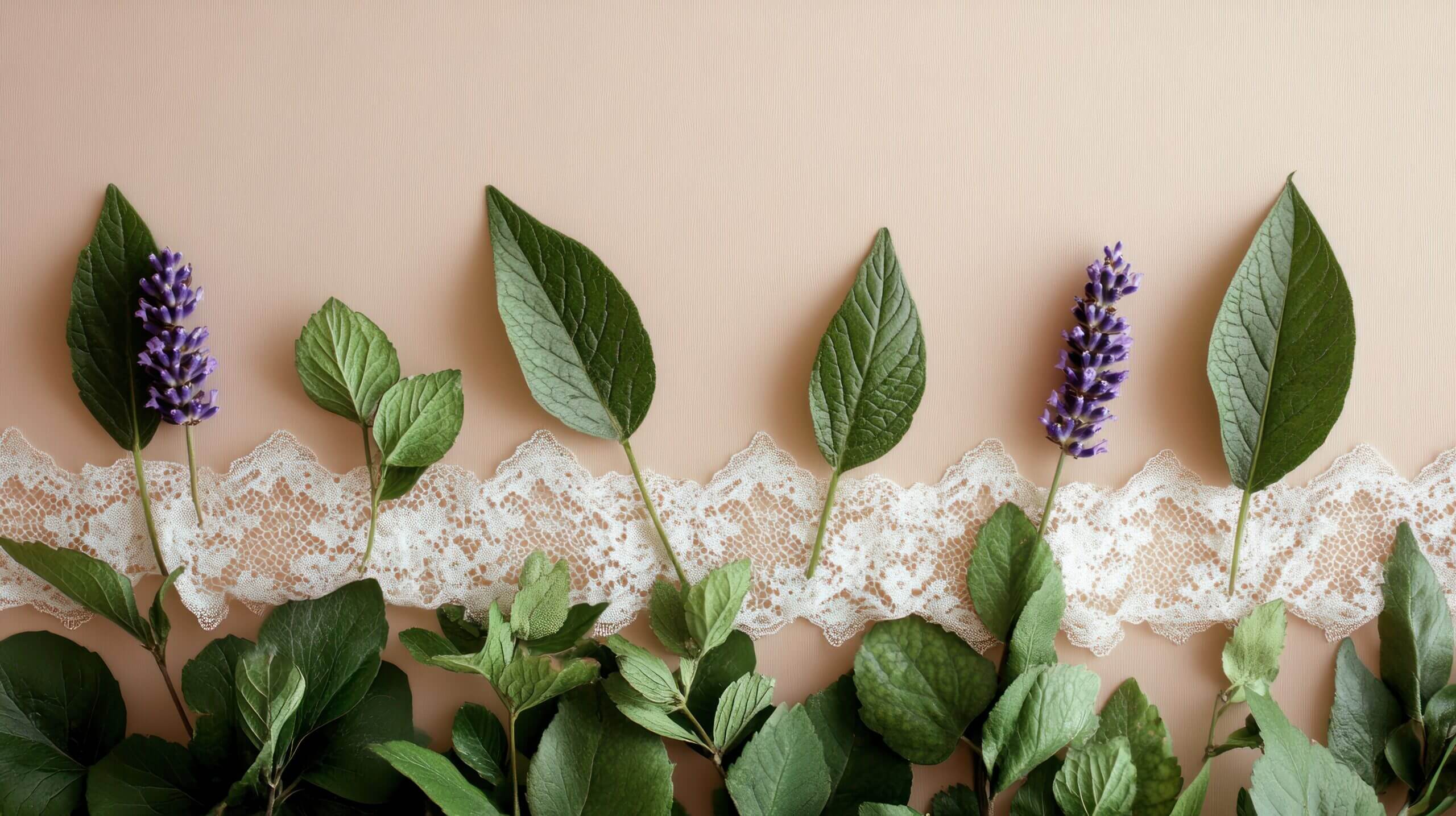 a decorative arrangement of leaves and lavender on a soft background with lace.